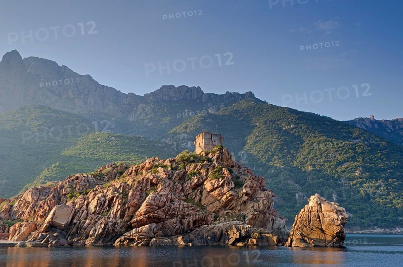 The Genoese Tower of Porto on top of a rocky hill and the Gulf of Porto