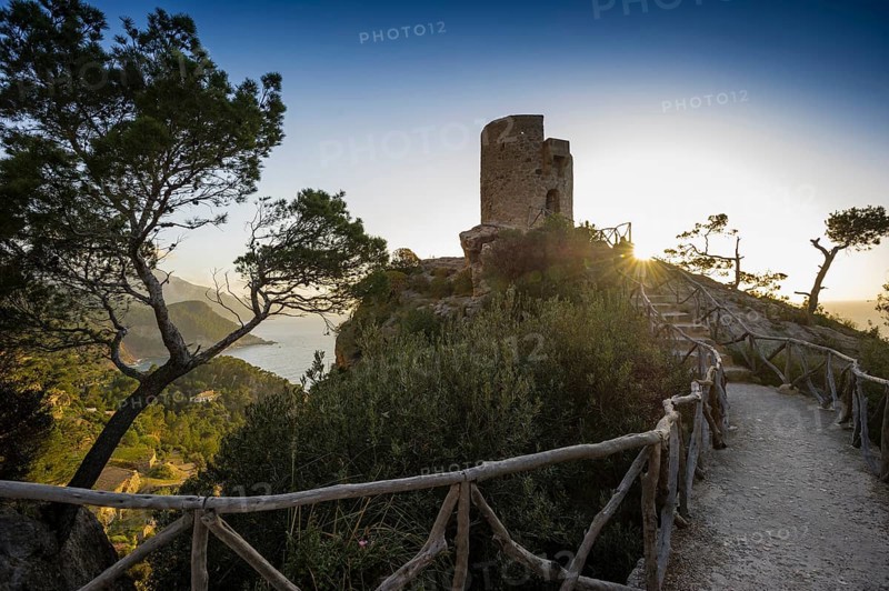 Old watchtower on the coast at sunset