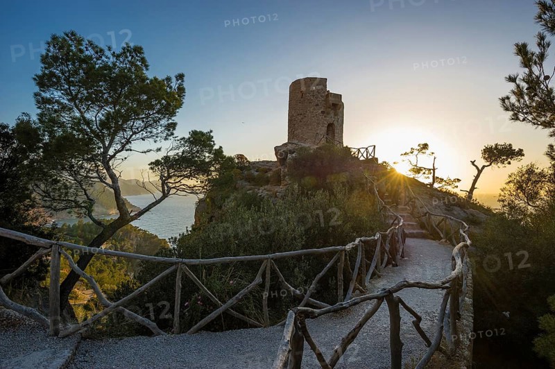 Old watchtower on the coast at sunset