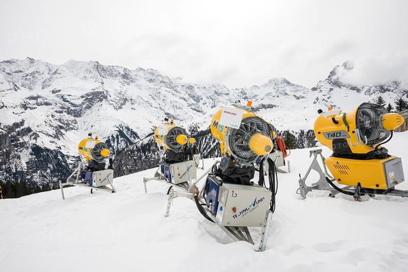 Snow cannon and snow-covered mountains