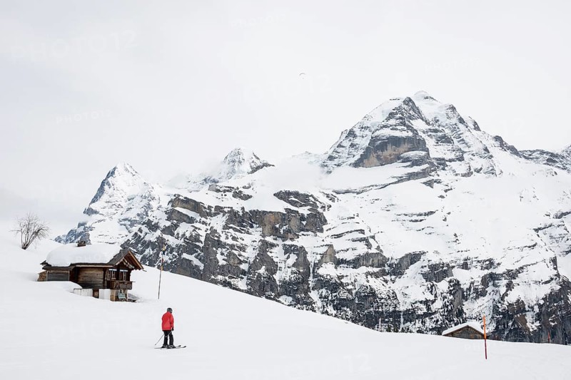 Old log cabin and skier