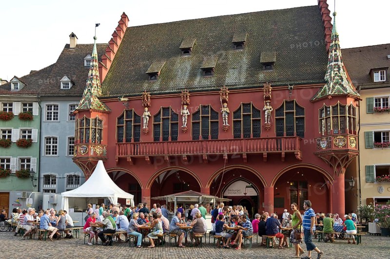 Wine stand and restaurants in front of the Historical Merchants Hall on Muensterplatz square or Cathedral Square