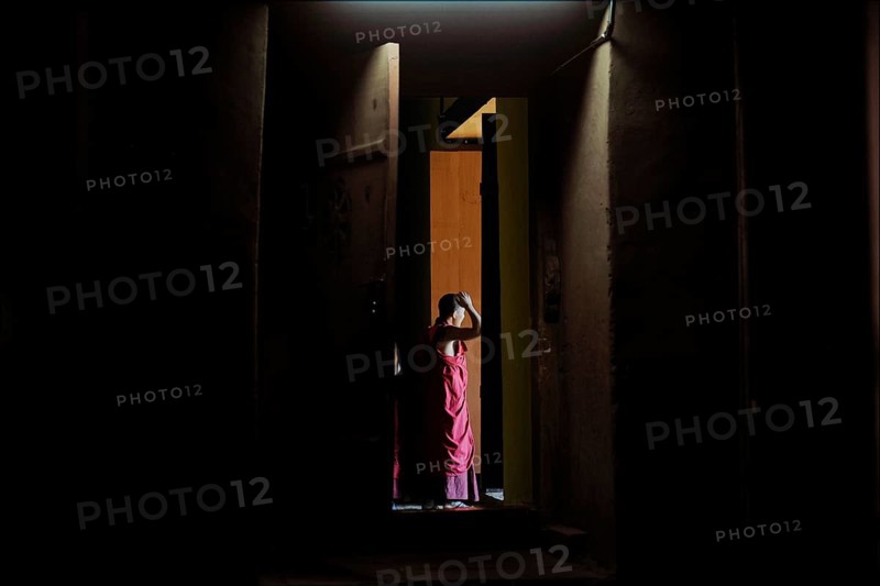 Monk leaving the room of a temple in Punakha Dzong fortress