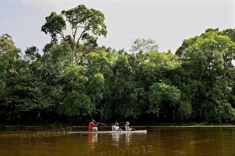 Tourists being rowed across the Nyong River