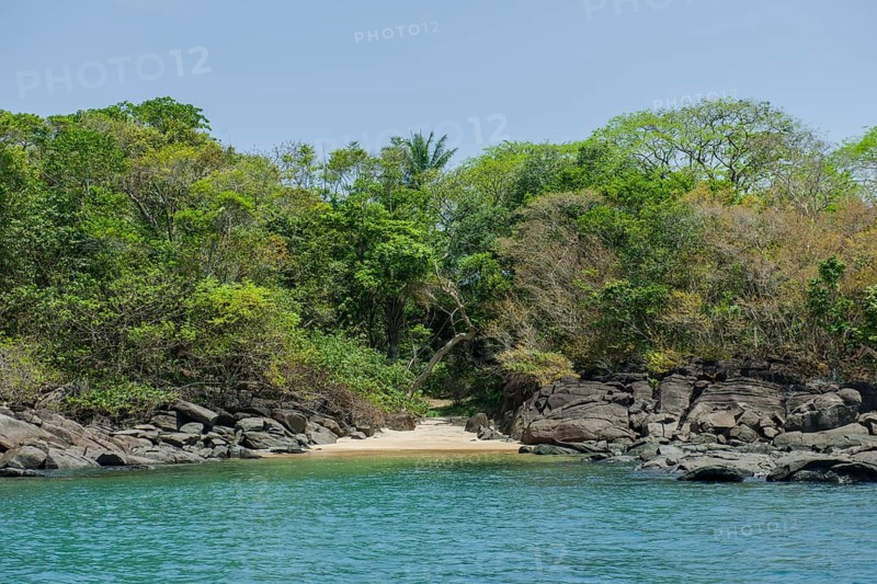Sandy beach between rocks near the village