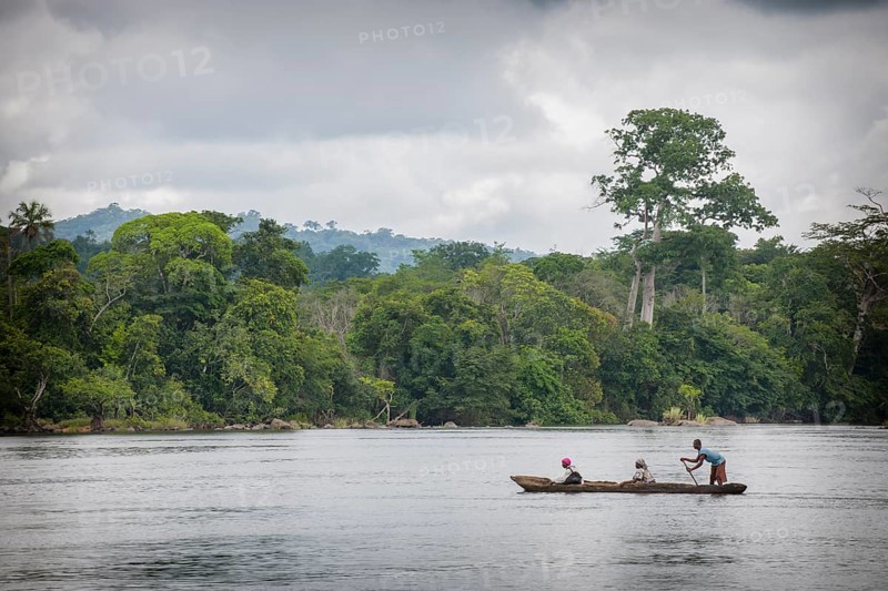 Ferryman taking passengers across the Moa River in a pirogue