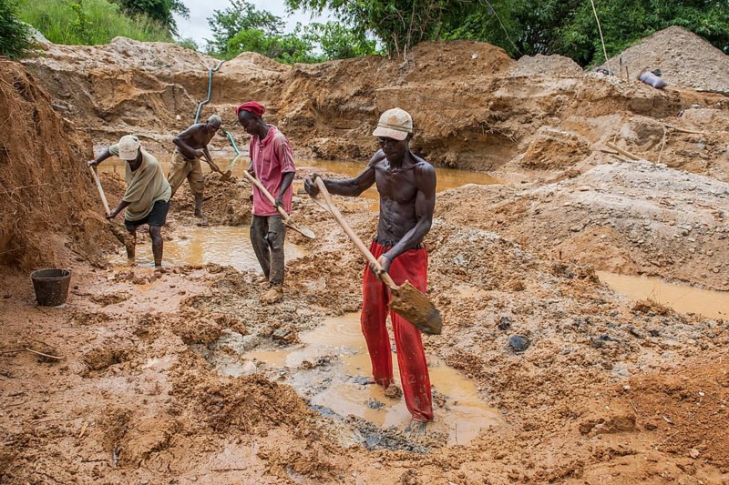 Workers digging at a diamond mine in the jungle