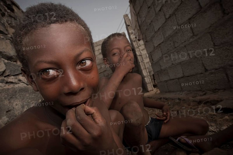 CChildren of the Rabelados religious community eating sea snails