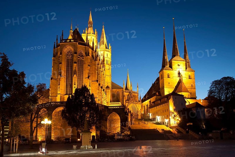 The illuminated Cathedral of St. Mary and St. Severi Church at dusk