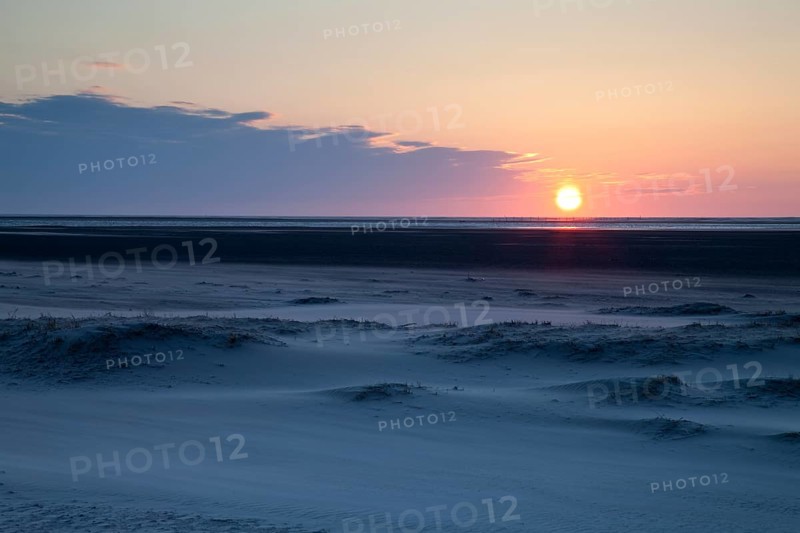 Sunset over the sand dunes on the Nordstrand beach