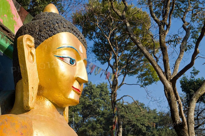 Head of a Buddha sculpture at the entrance of Swayambhunath Stupa