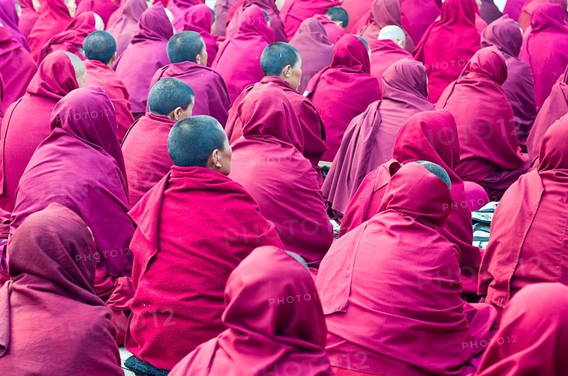 Many nuns wearing red cloths listening the teachings of Taklung Tsetru Rinpoche in the backyard of Junbesi Gompa