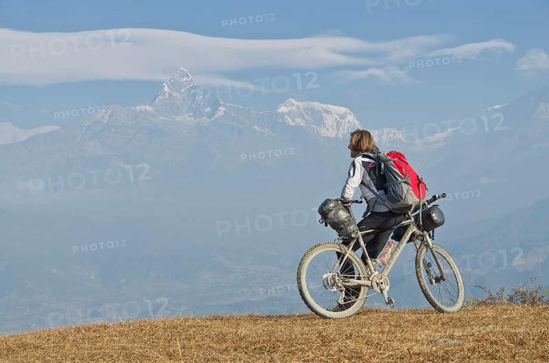 Cyclist leaning on his bike