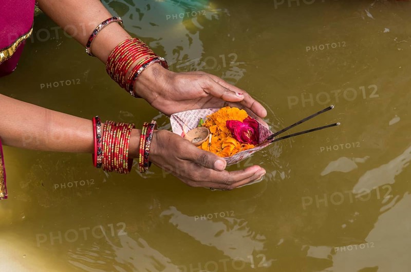Woman offering flowers at the Sangam