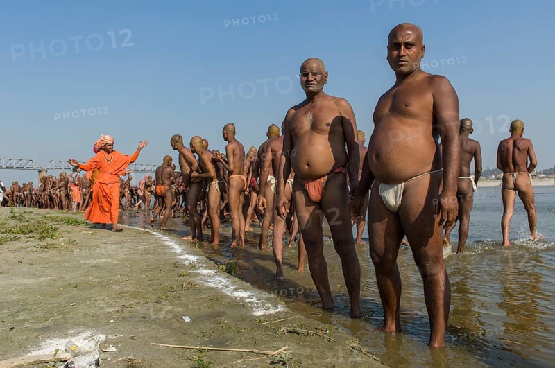 Group of men standing in the river Ganges