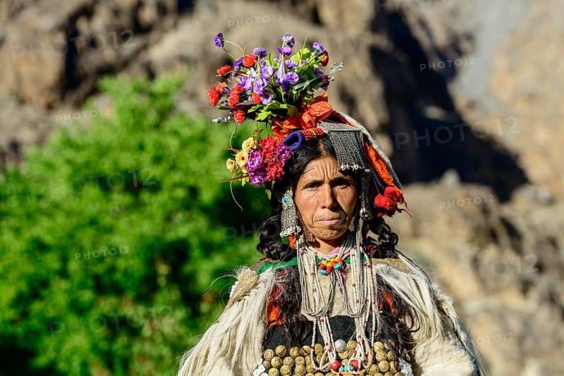 Woman of the Brokpa tribe wearing traditional dress with flower headdress