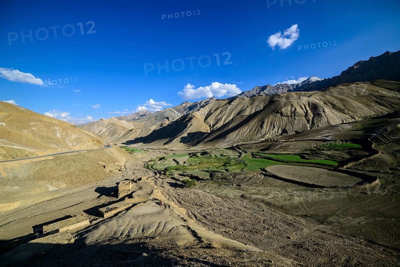 A small village with green fields in a barren landscape at an altitude of 4.000 m