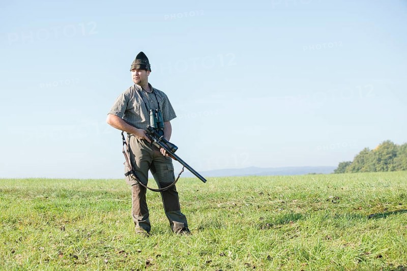 Hunter standing on a meadow