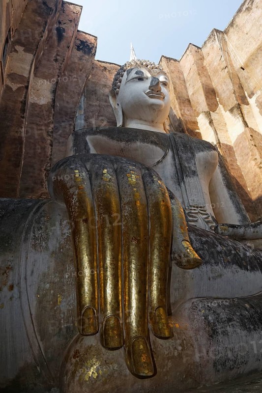 Gold-plated hand of the Seated Buddha statue of Phra Achana in Wat Si Chum Temple
