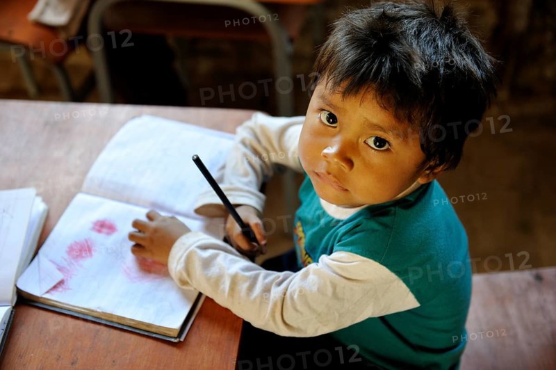 Boy with a book in a classroom