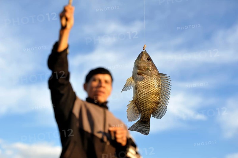 Indigenous man with a fish on the hook