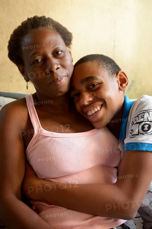 Boy hugging his mother in the slums