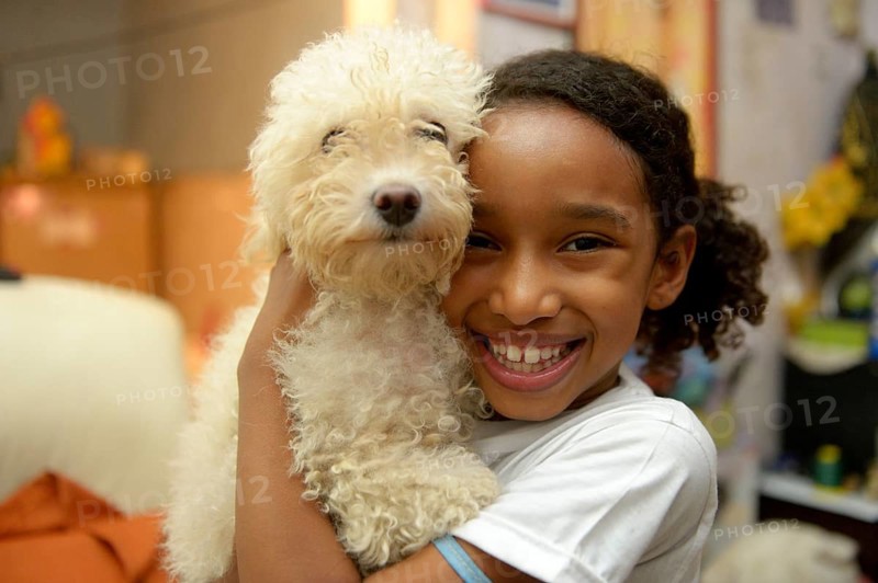 Girl with a poodle in a slum or favela