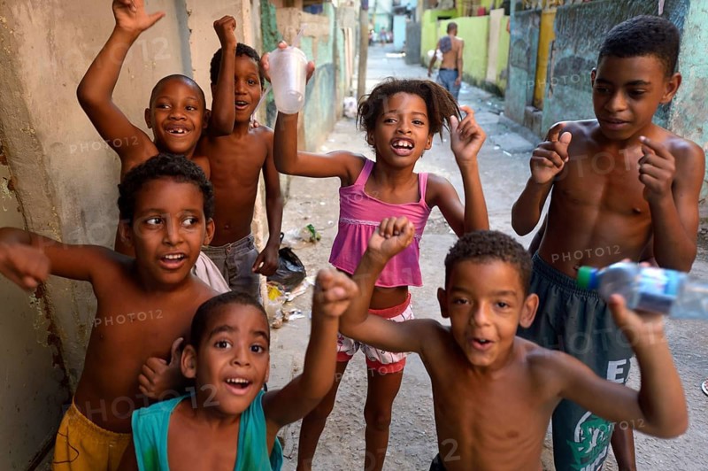 Children cheering happily in a slum or favela