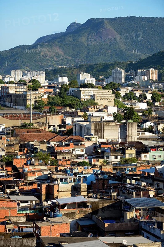 View over a slum or favela towards the high-rise apartment buildings where the urban middle class live