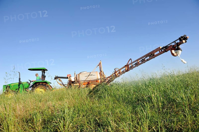 Spraying of pesticides on a field in a Mennonite community