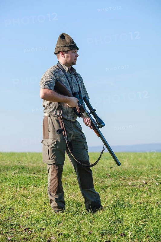 Hunter standing on a meadow