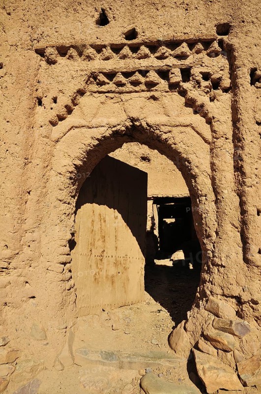 Clay stucco of a decaying entrance gate in the Kasbah Tamnougalt near Agdz