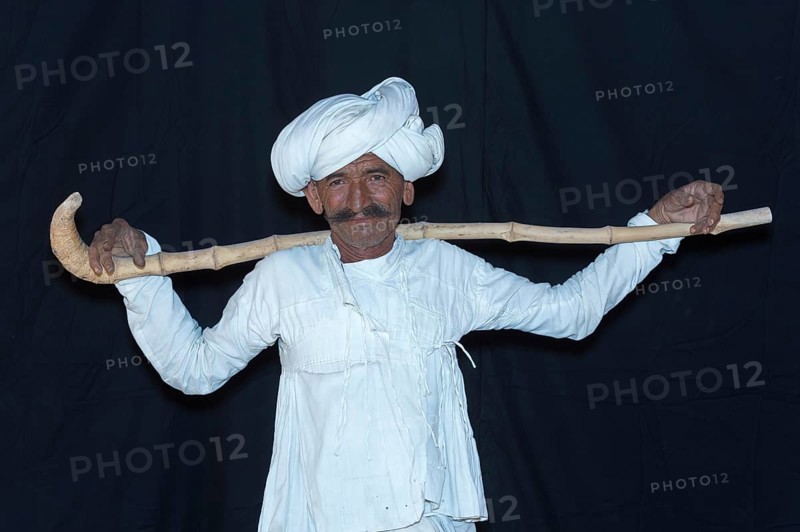 Rabari Man wearing a white clothes with turban and holding walking stick