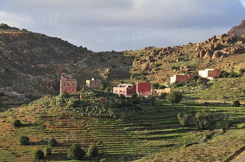 Farmhouses in a barren mountain landscape