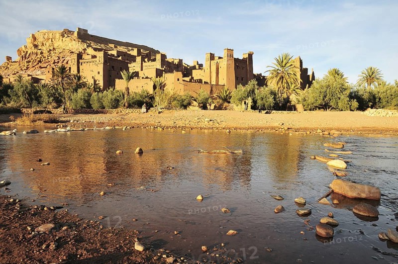 The Kasbah and the fortified city or ksar Ait Ben Haddou reflected in the Asif Mellah river