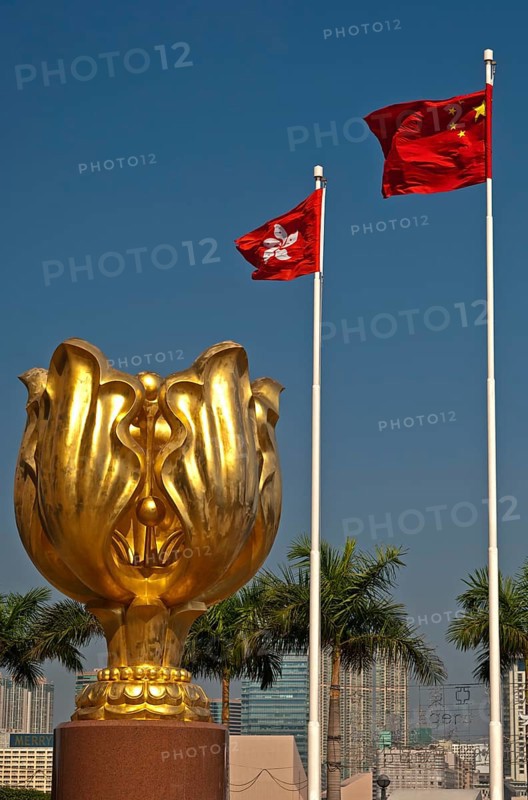 Sculpture of a gilded eternal Bauhinia flower with the flags of Hong Kong and China