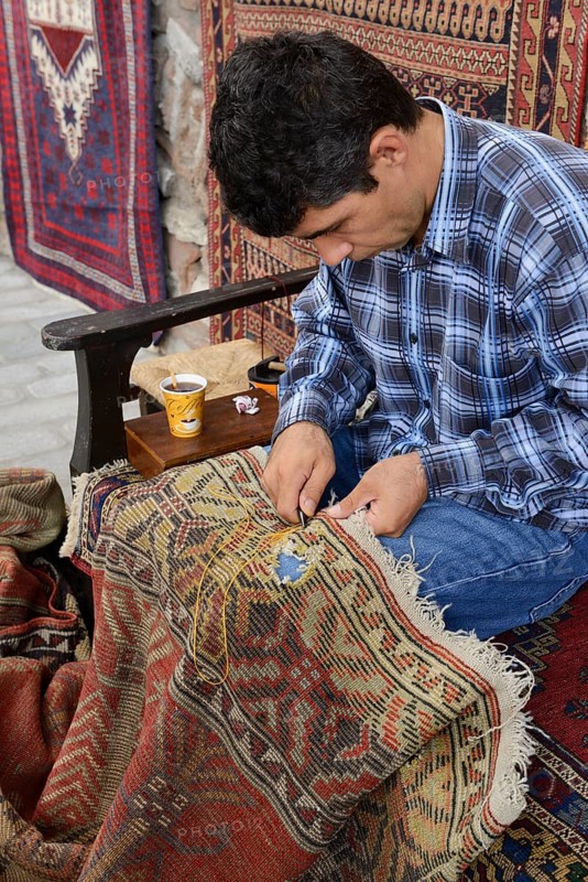 Man repairing a used carpet