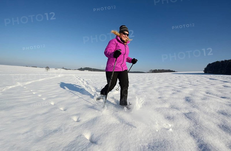 Woman snowshoe walking