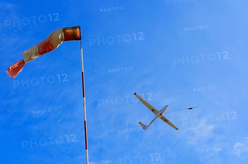 Windsock and a glider during a winch launch against the wind