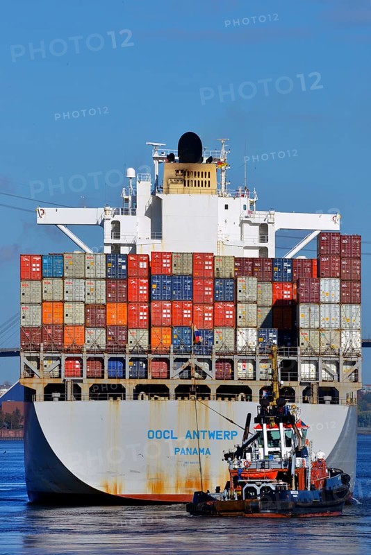 Container ship OOCL Antwerp with the tug Bugsier 10 at Koehlbrand in the Elbe River