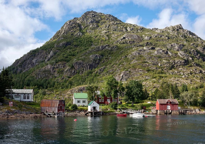 Colourful wooden houses on the shore with a jetty