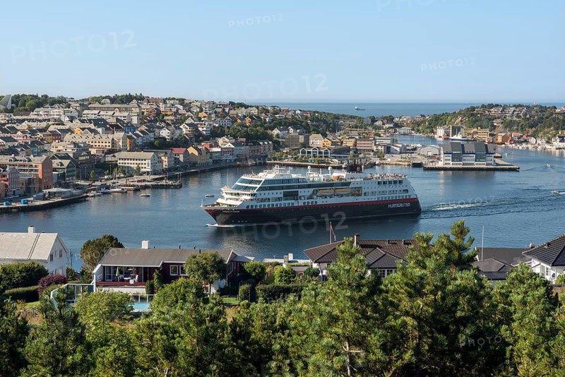Cityscape with the harbour as a cruise ship is departing