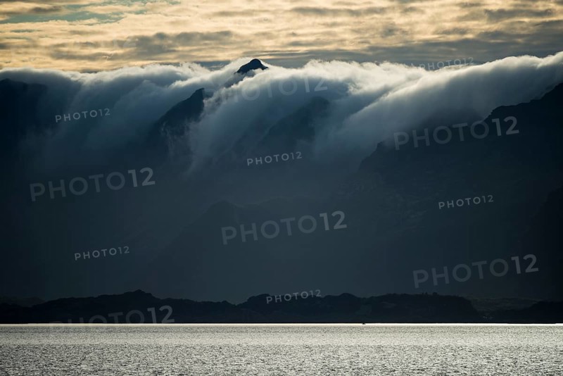 Clouds rolling over mountains