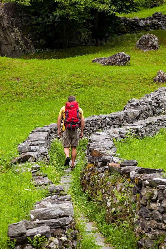 A man hiking along a Mulattiera near Sabbione