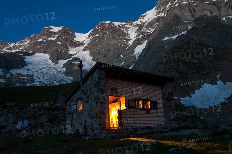 Schmadrihuette mountain hut illuminated at dusk
