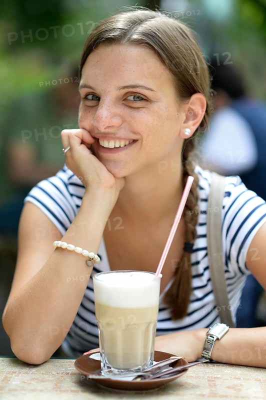 Young woman with a latte macchiato