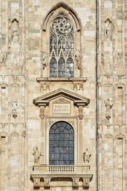 Window over the main portal of the west facade of Milan Cathedral or Duomo di Santa Maria Nascente