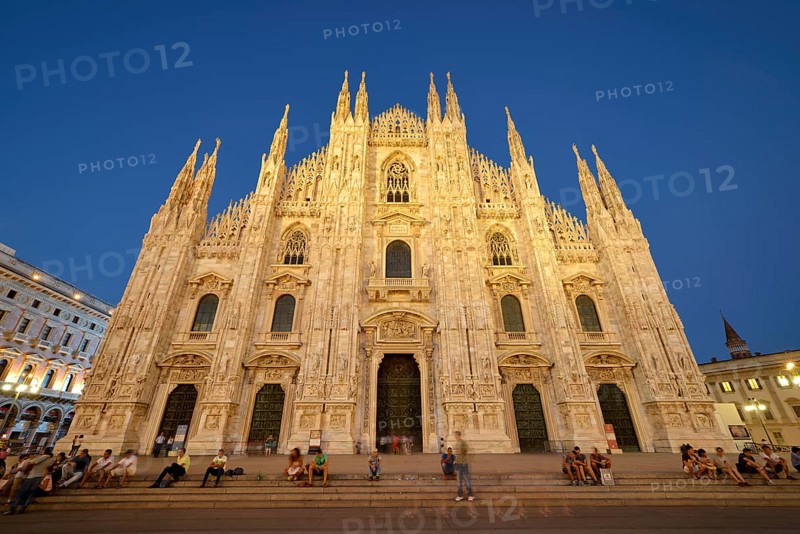 Tourists in front of the west facade of Milan Cathedral or Duomo di Santa Maria Nascente