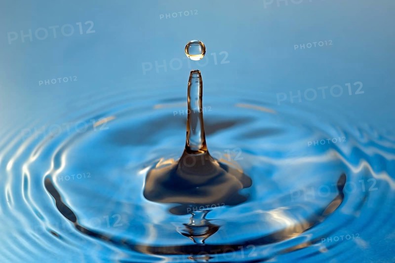 Water droplets falling onto water surface