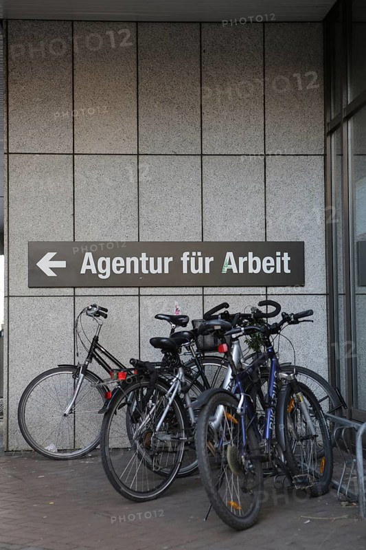 Bicycles parked in front of the sign 'Agentur fuer Arbeit'